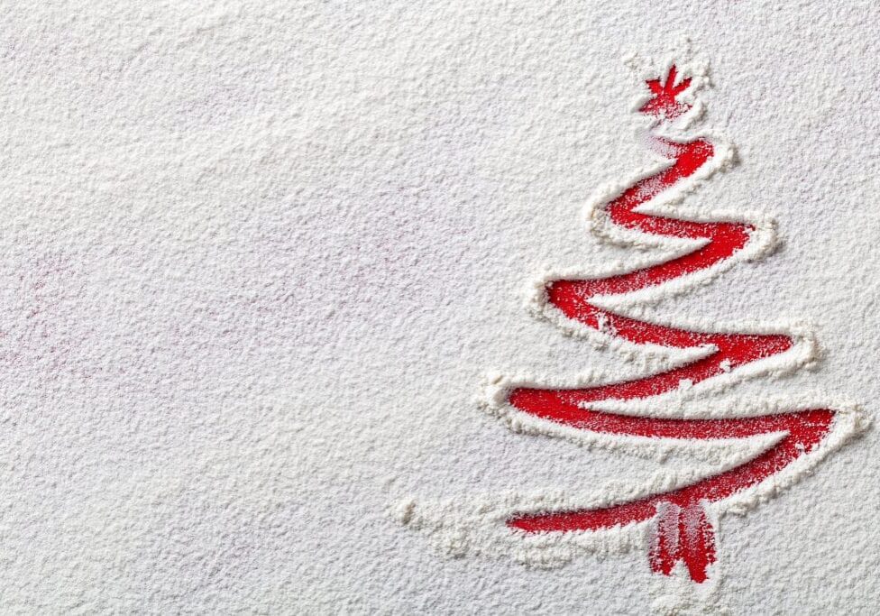 Christmas tree on flour background. White flour looks like snow. Top view